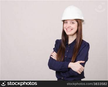 Portrait of a young beautiful girl engineer, architect in helmet