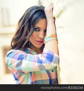 Portrait of a young beautiful woman in a urban background