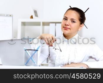 POrtrait of a young beautiful woman in business wear at work