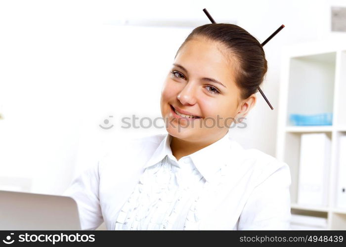 POrtrait of a young beautiful woman in business wear at work