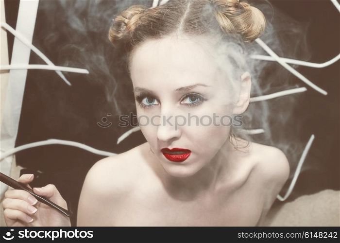 Portrait of a young beautiful woman in the smoke