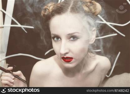 Portrait of a young beautiful woman in the smoke