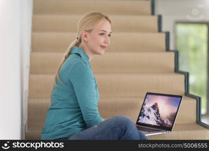 portrait of a young beautiful woman on the stairs in her luxurious home