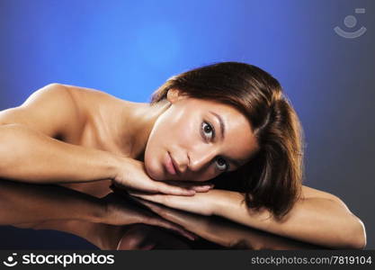 portrait of a young beautiful woman. portrait of a young beautiful woman lying on a table with reflection