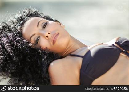 Portrait of a young black woman, afro hairstyle, wearing bikini