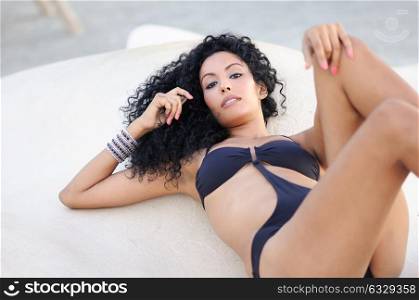 Portrait of a young black woman, afro hairstyle, wearing bikini