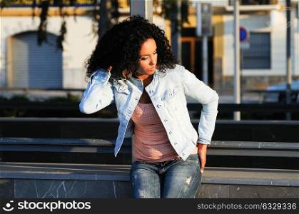 Portrait of a young black woman, model of fashion in urban background