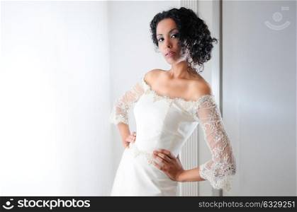 Portrait of a Young black woman, model of fashion, wearing a wedding dress