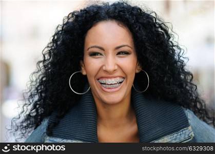 Portrait of a young black woman smiling with braces