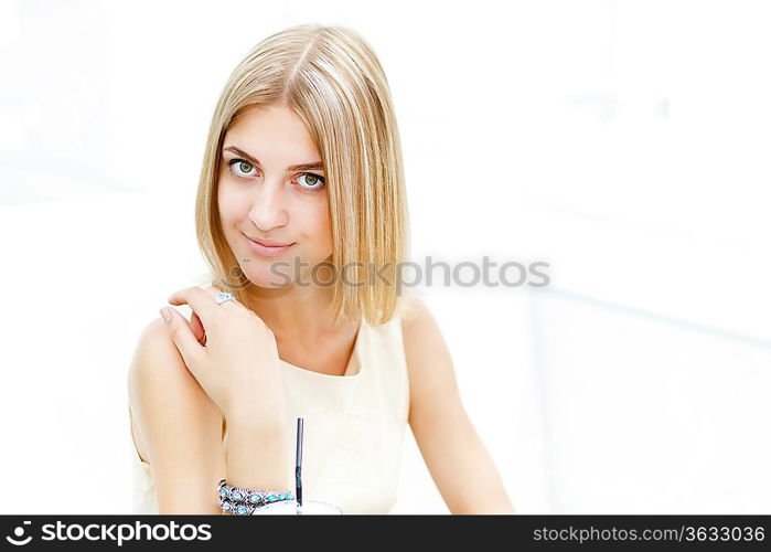 Portrait of a young blond woman sitting in cafe