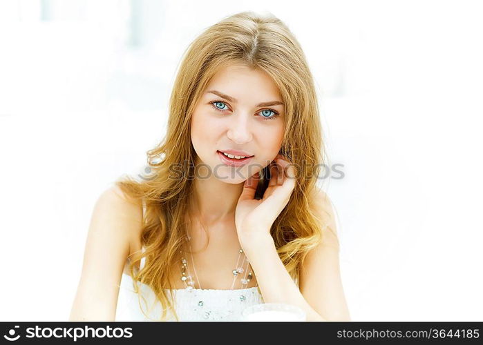 Portrait of a young blond woman sitting in cafe