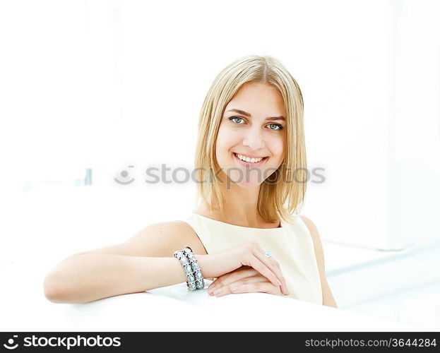 Portrait of a young blond woman sitting in cafe