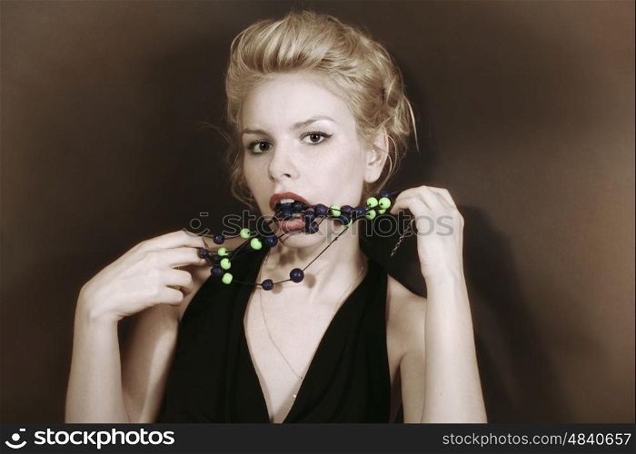Portrait of a young blonde woman with beads