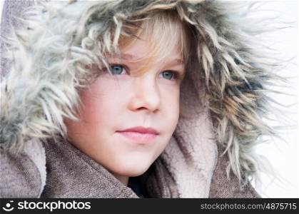 Portrait of a young boy in a fake fur hood