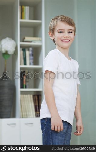 Portrait of a young boy in casuals smiling at home