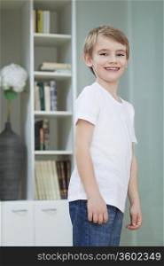 Portrait of a young boy in casuals smiling at home