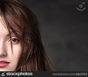 Portrait of a young brunette lady on white background