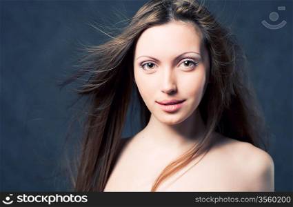 Portrait of a young brunette lady on white background
