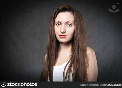 Portrait of a young brunette lady on white background