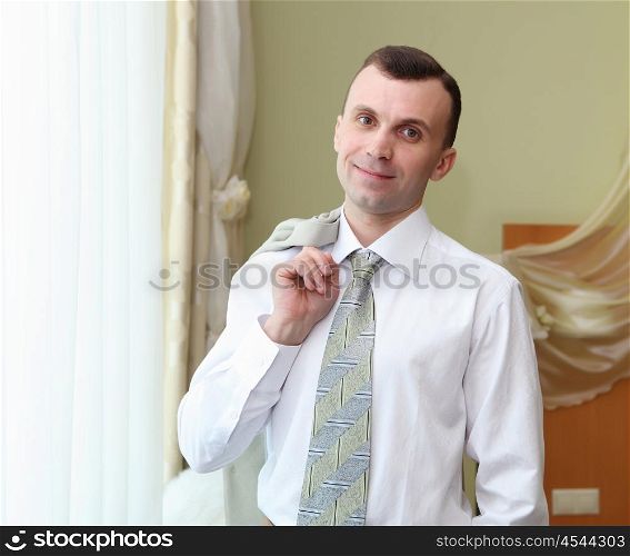 portrait of a young business man in suit in hotel room