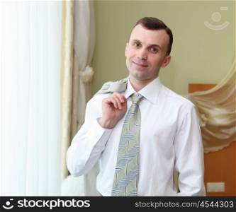 portrait of a young business man in suit in hotel room