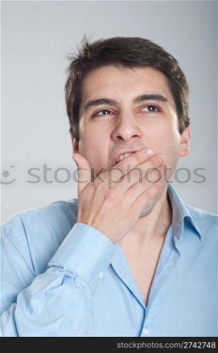 portrait of a young business man yawning