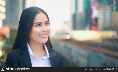 Portrait of a young business woman is smiling in city . Business people , confident people concept. 