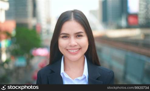 Portrait of a young business woman is smiling in city . Business people , confident people concept. 