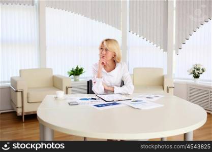 portrait of a young business woman with papers in the offcie