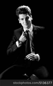 Portrait of a young businessman, isolated on black background