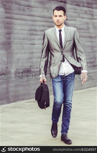 Portrait of a young businessman near a office building