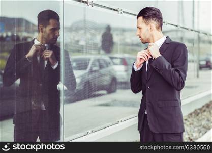 Portrait of a young businessman near a office building