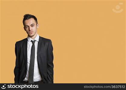 Portrait of a young businessman over colored background