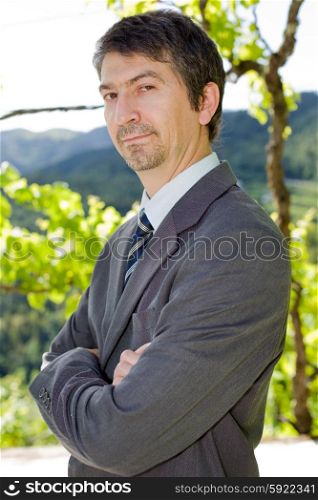 portrait of a young businessman thinking, outdoors