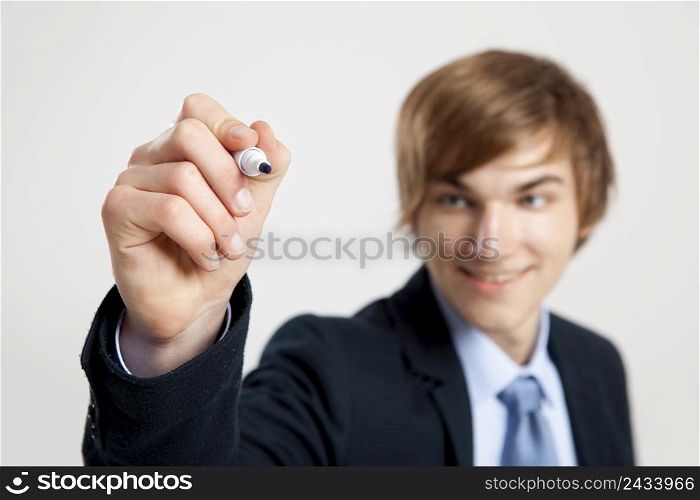 Portrait of a young businessman writting something on a glass writeboard