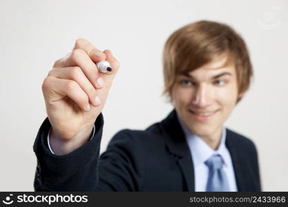 Portrait of a young businessman writting something on a glass writeboard