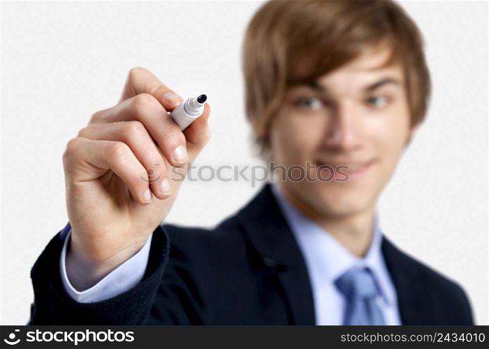 Portrait of a young businessman writting something on a glass writeboard