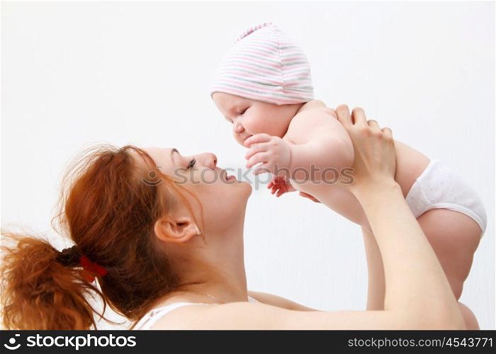 Portrait of a young child and his mother a white background. Baby.