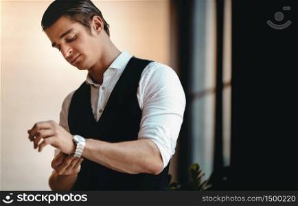 Portrait of a Young Confident CEO or Leader in the Modern Workplace. Confident Caucasian Businessman in Formal Dress is Wearing Watches