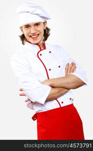 Portrait of a young cook in uniform preparing meal