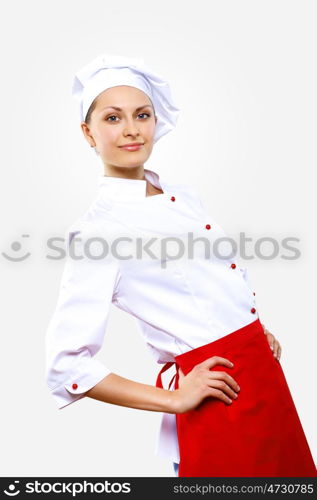 Portrait of a young cook in uniform preparing meal