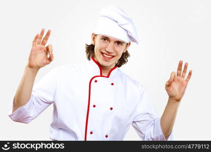 Portrait of a young cook in uniform preparing meal