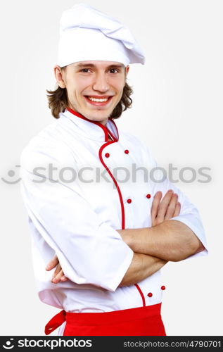 Portrait of a young cook in uniform preparing meal