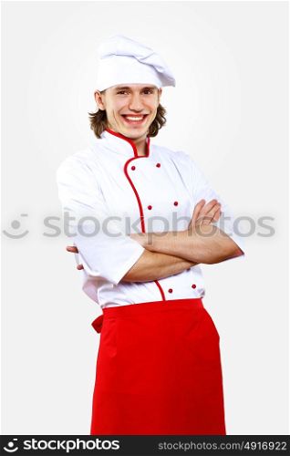 Portrait of a young cook in uniform preparing meal