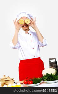 Portrait of a young cook in uniform preparing meal