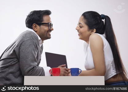 Portrait of a young corporate couple talking each other