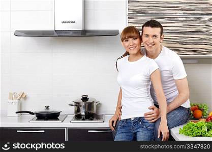 Portrait of a young couple at kitchen