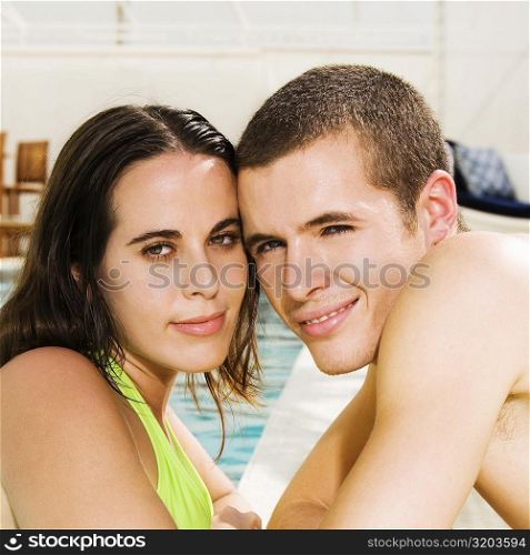 Portrait of a young couple at the poolside