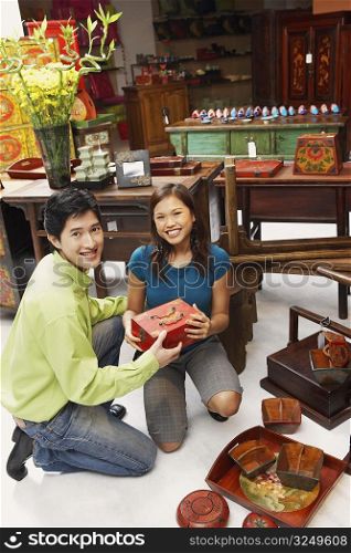 Portrait of a young couple choosing merchandise in a store