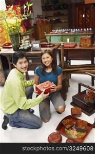 Portrait of a young couple choosing merchandise in a store
